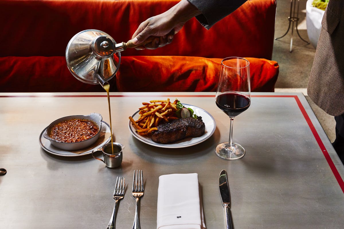 a person sitting at a table with a plate of food
